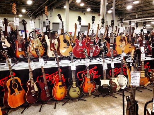 Assorted display of vintage guitars at Guitar Center's booth ...