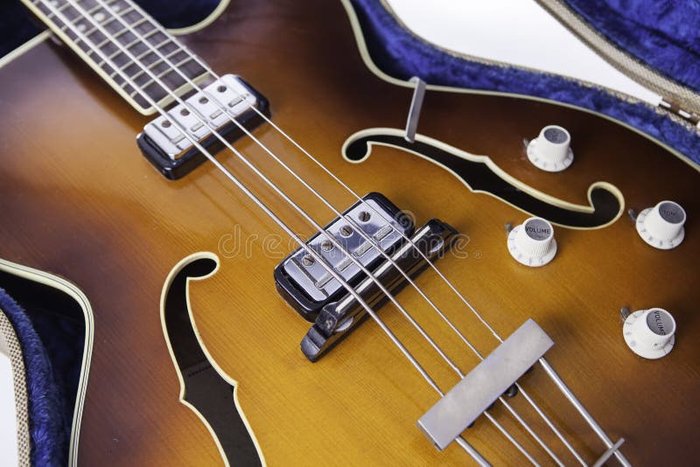 Vintage F-hole Semi-acoustic Bass Guitar Stock Image - Image of a classic semi-hollow bass that showcases its design and potential drawbacks, including feedback issues and structural aspects.