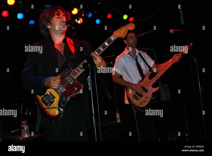Musician Michael Imperioli performs on stage, which visually represents the dynamic between studio recordings and live performances.