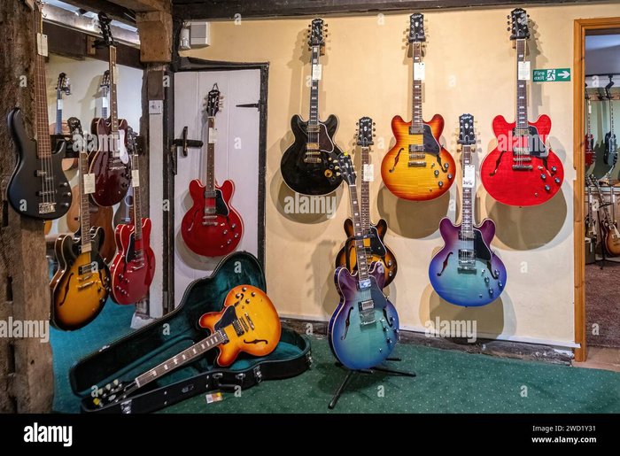 Guitar village specialist shop selling guitars, showcasing an array of guitars on display inside the music shop.