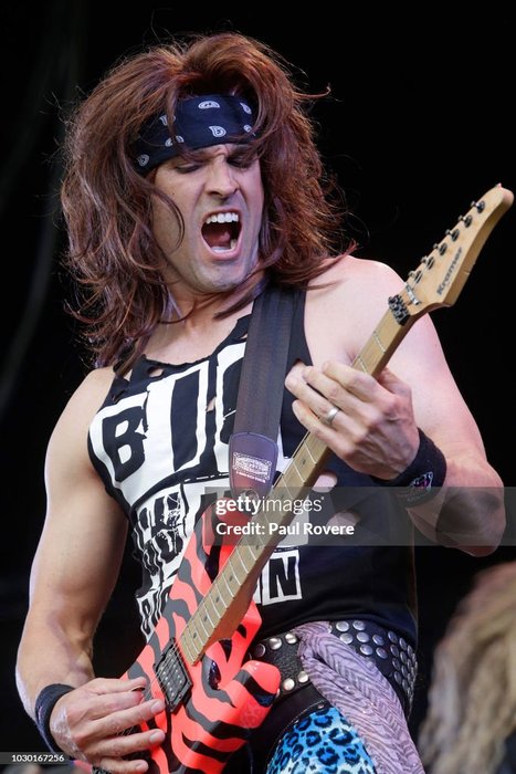 Steel Panther guitarist Satchel performs on stage at the Soundwave, showcasing the prominence of steel guitar in their music.