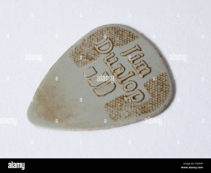 A close up view of a worn guitar pick