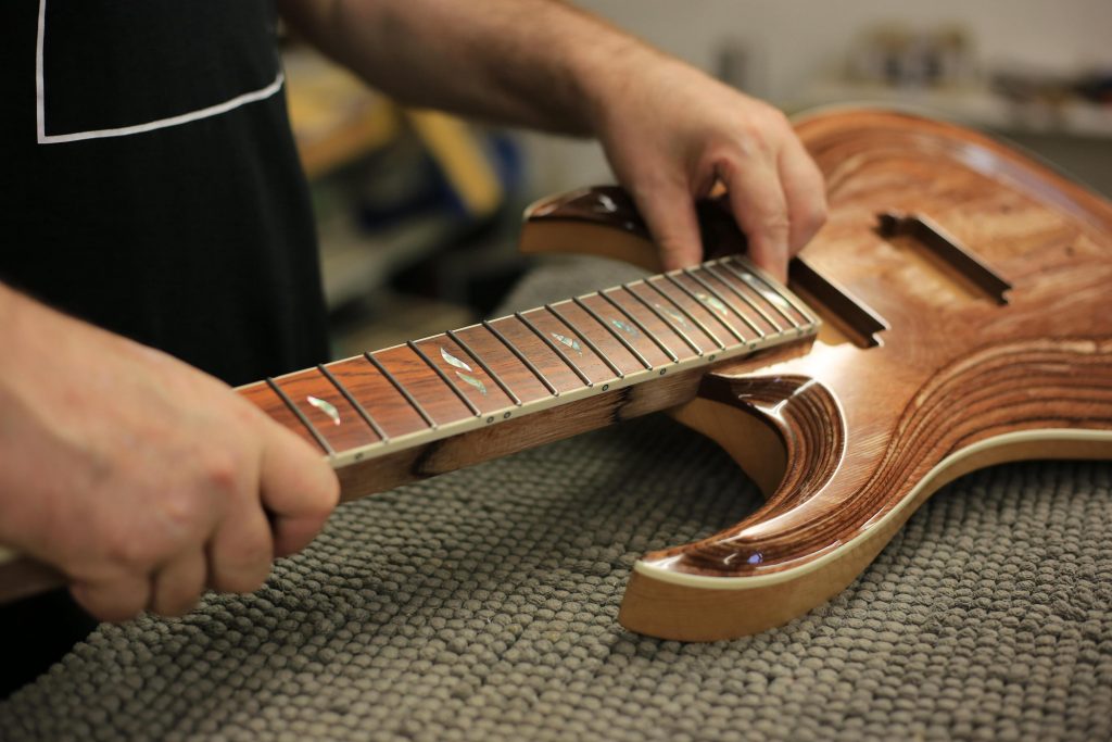 Ergonomic guitar neck design tailored to hand anatomy for enhanced comfort.