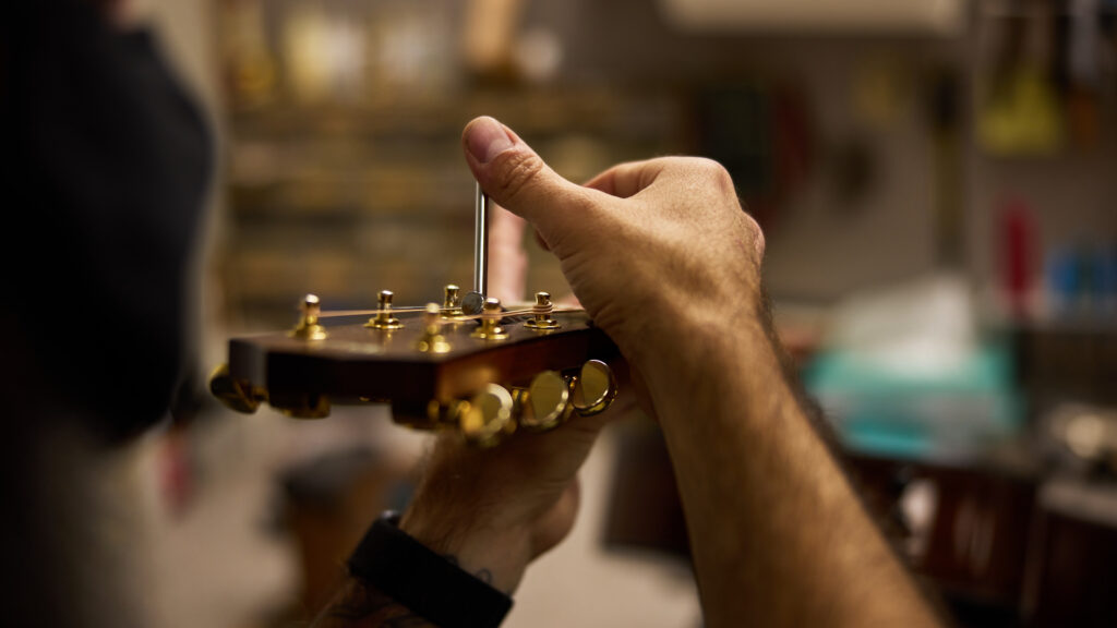 Expert guitar setup demonstration focusing on truss rod adjustment.