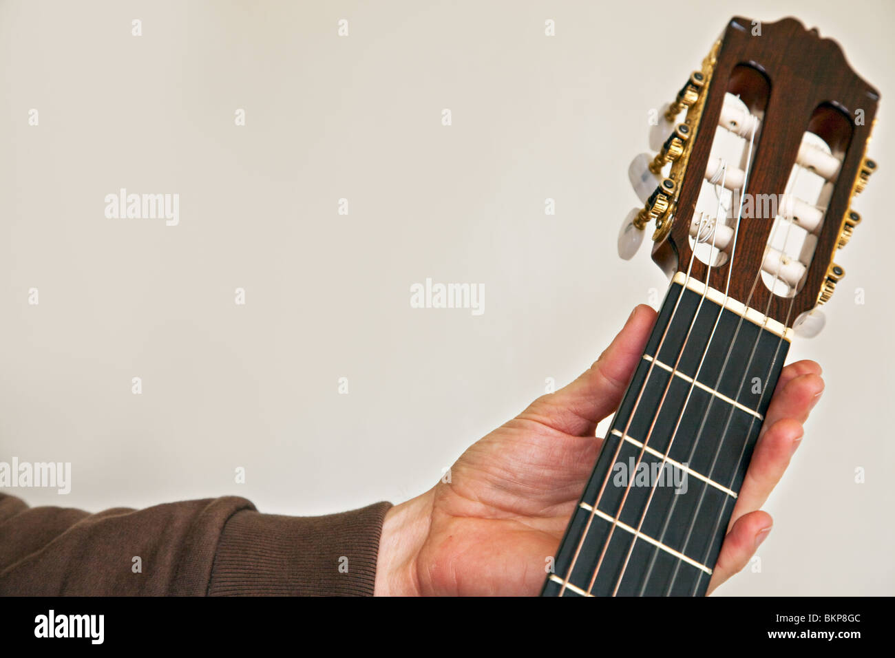 Close-up of finger positioning on a nylon-string classical guitar.