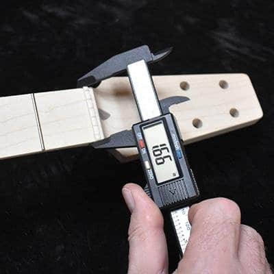 Measuring Tools that specifically highlight nut width, which is directly related to string spacing and neck width on a guitar.